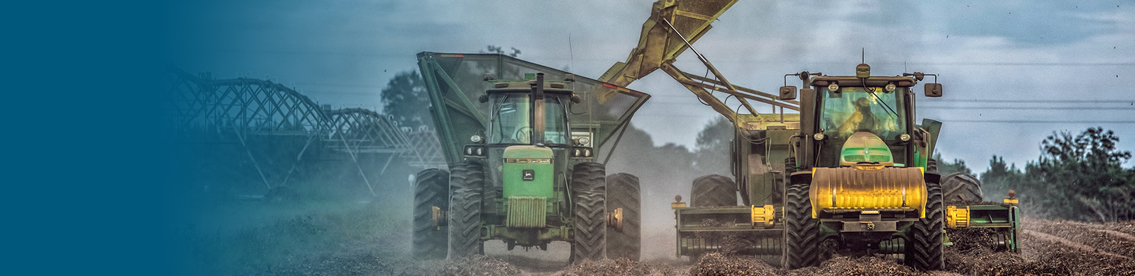 Two tractors servicing a field