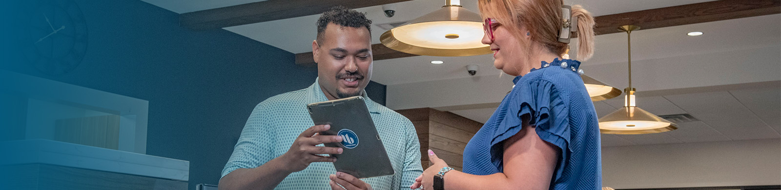 Two people reviewing a tablet together